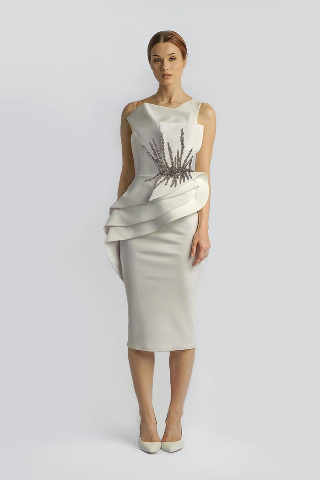 A woman wearing a COURT CIVIL WEDDING STRUCTURED EMBELLISHED DRESS IN CREAM posed against a white backgroud- ANITABEL