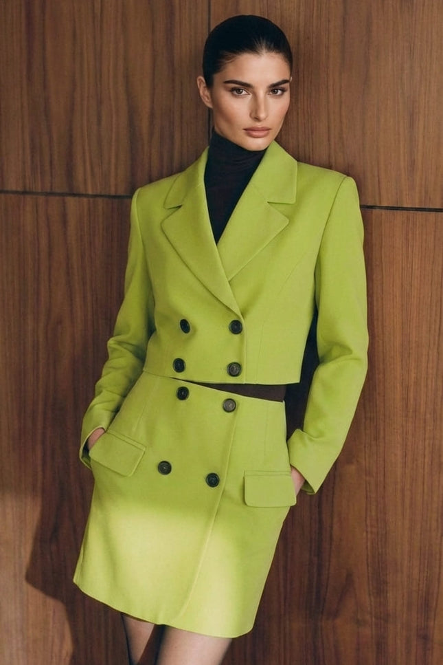Woman wearing a bright green suit against a wooden paneled wall