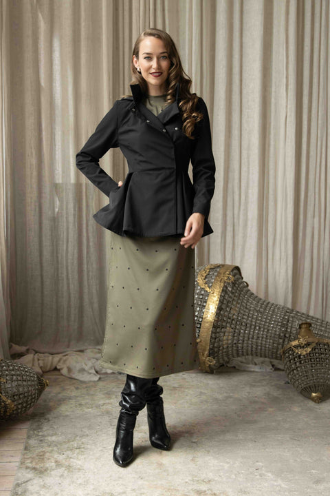 Polka dot green satin midi dress with long sleeves, back ribbon tie, and flowing skirt designed for elegance and comfort.