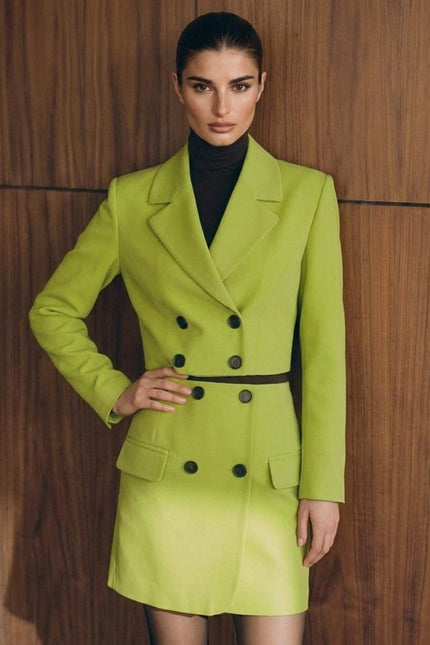 Woman wearing a bright green suit against a wooden background