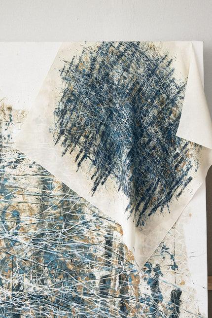 Abstract art piece with blue and white brush strokes on a light background
