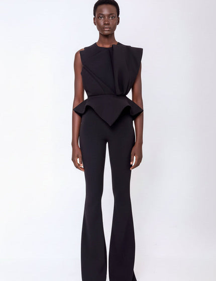 A woman wearing the JADE PEPLUM BLOUSE AND PANTS SET IN BLACK by  ANITABEL