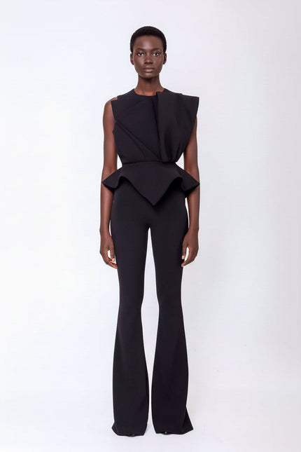 A woman wearing the JADE PEPLUM BLOUSE AND PANTS SET IN BLACK by  ANITABEL