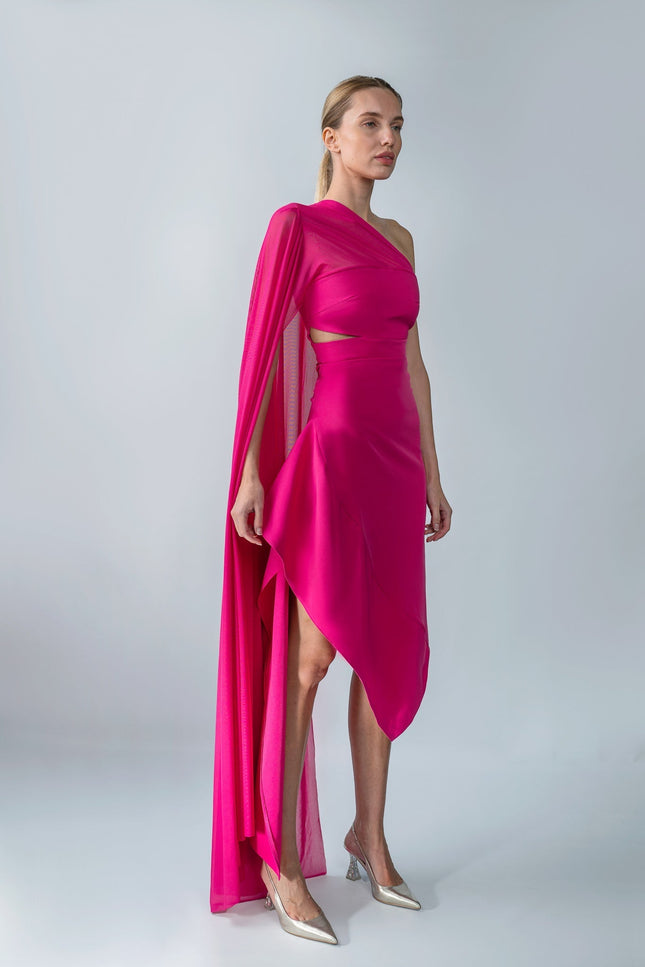 Model wearing a bright pink one-shoulder top and skirt set with a draped effect on a gray background