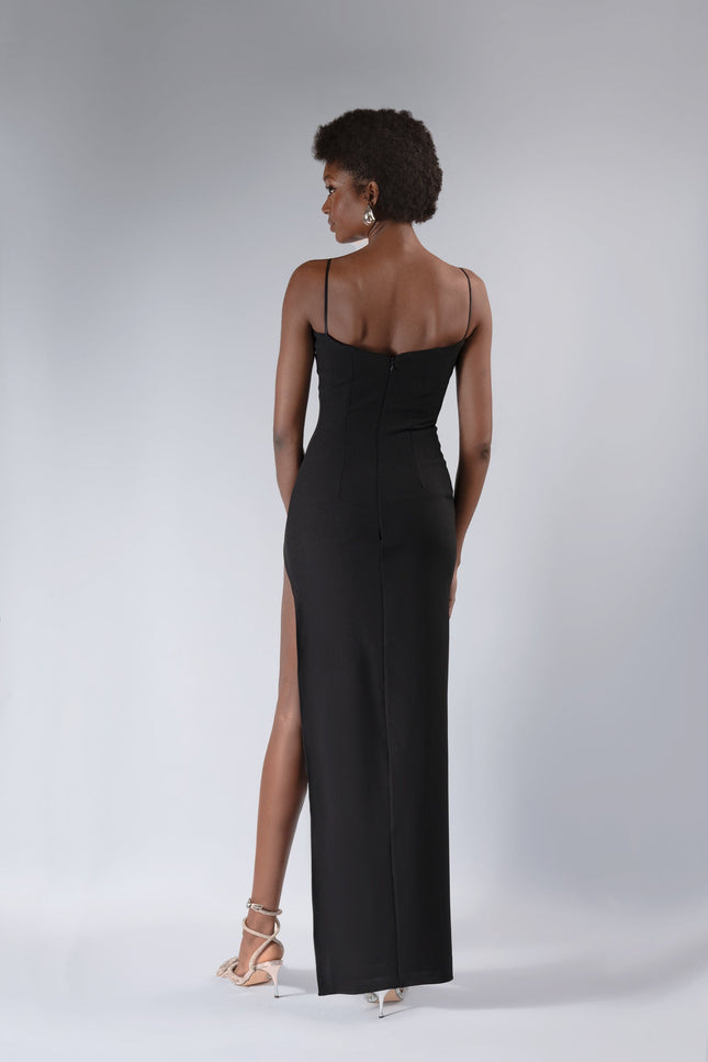 a woman wear the LEAH ANKLE LENGTH  cut out dress in BLACK by ANITABEL posed against a white background