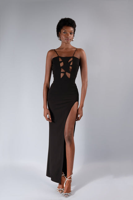 a woman wear the LEAH ANKLE LENGTH  cut out dress in BLACK by ANITABEL posed against a white background