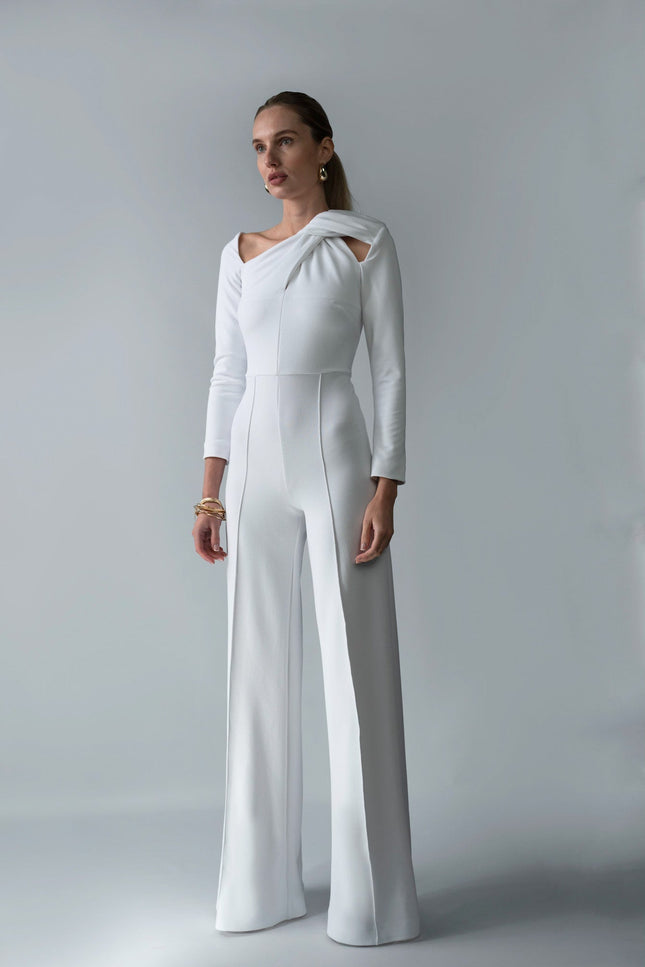 A woman wearing Meera white jumpsuit by  posed against a white background.