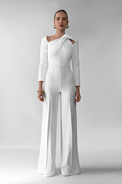A woman wearing Meera white jumpsuit by  posed against a white background.