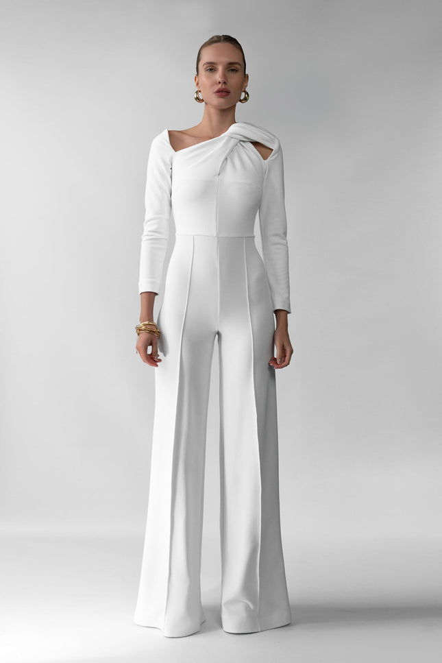 A woman wearing Meera white jumpsuit by  posed against a white background.