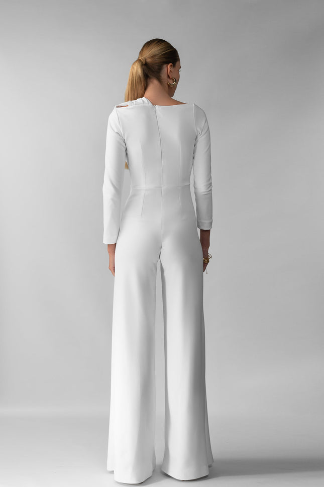 A woman wearing Meera white jumpsuit by  posed against a white background.