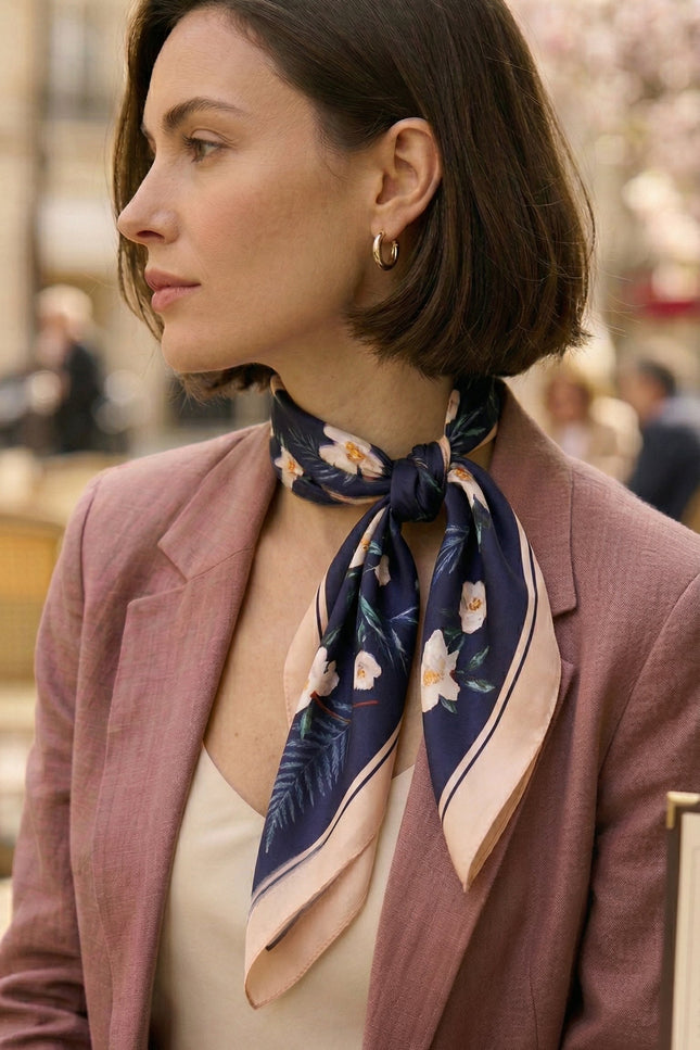 For the early morning chill, opt for the grounding, midnight tones of the Serene Camellia Double-Sided Silk Scarf. It lends a sense of quiet authority and intellectual depth to your blazer or trench coat.
