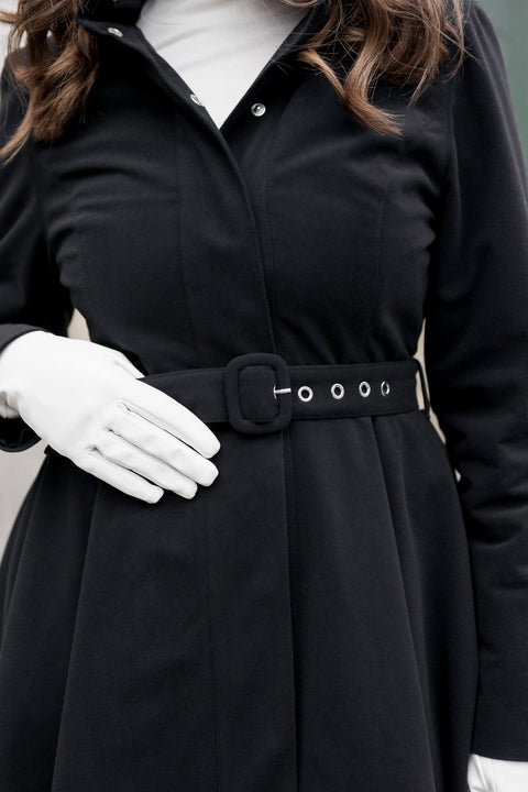 Black waterproof long coat with insulated lining, ideal for cold weather city or outdoor walks.