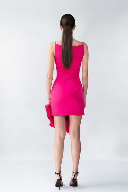 Woman wearing a bright pink dress on a white background