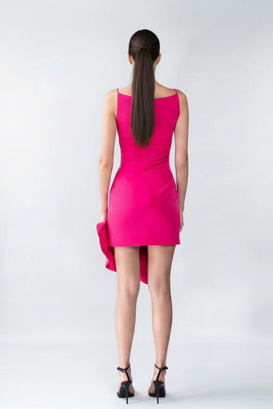 Woman wearing a bright pink dress on a white background