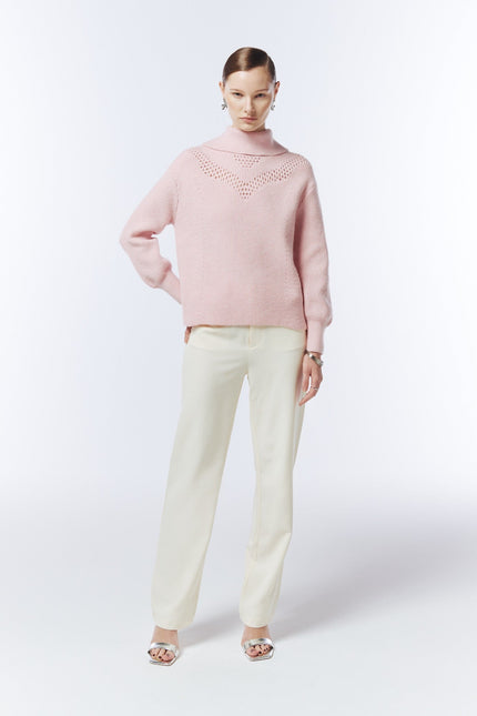 Blush pink pointelle-detail funnel-neck jumper on model, front view showing the relaxed fit and long sleeves.