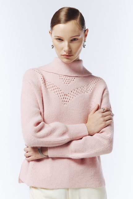SOUR FIGS blush pink pointelle-detail funnel-neck jumper, close-up showing geometric openwork across the chest and ribbed cuffs.