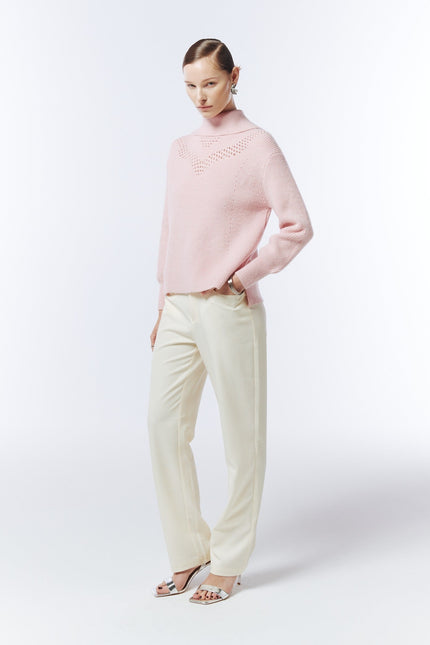 SOUR FIGS blush pink funnel-neck jumper, three-quarter model view showing the openwork yoke and side hem slit.