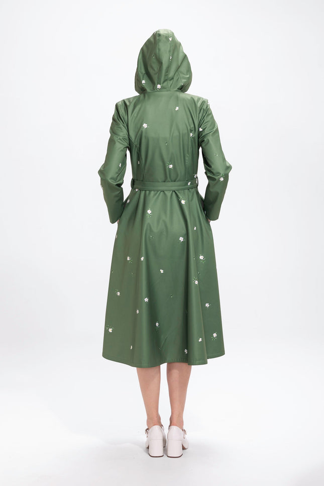 Back view of green women's double-breasted coat with floral print and structured silhouette