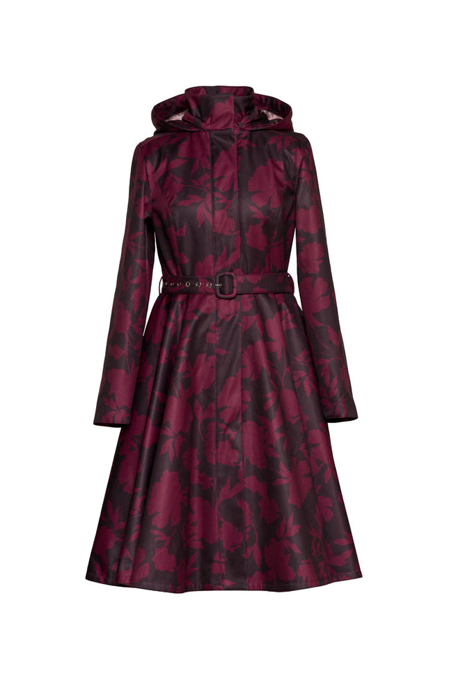 A long-sleeved hooded raincoat with a dark burgundy and dark brown floral pattern by RainSisters, featuring a matching waist belt with a silver buckle, shown on a plain white background.