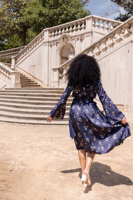 Meadow Dream floral midi dress featuring an open shoulder design, adjustable waist, and elegant drape