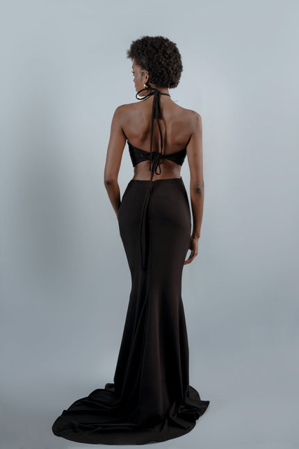 A woman wearing the Roseline long mermaid dressin black by Anitabel, posed against a light grey background.