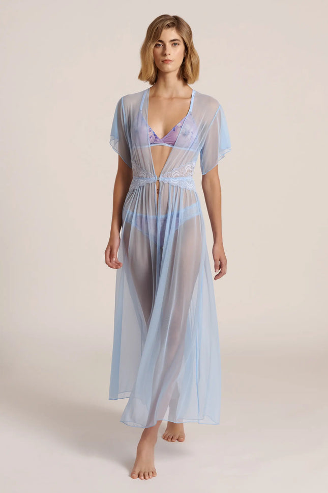 Front view of a model wearing a long, blue mesh robe, posing in a studio