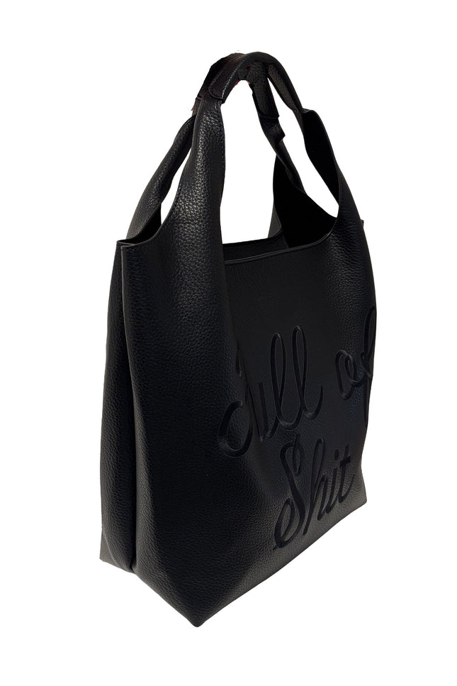 Lilly Loves black shoulder handbag with subtle "Full of Shit" print, featuring a sleek design and shoulder strap, side view image.