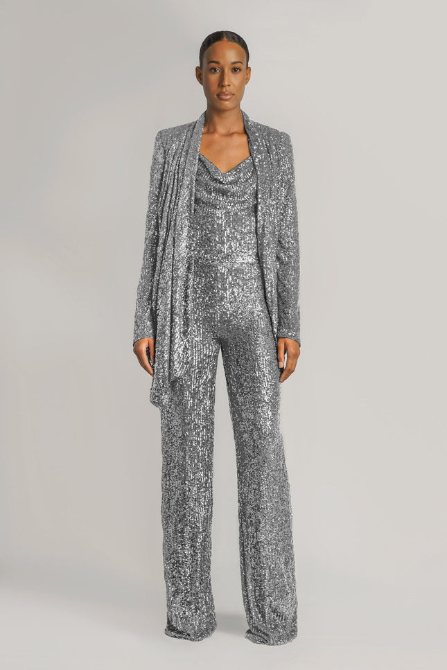 A woman wearing the TIA SEQUIN STRAIGHT LEG PANTS IN SILVER posed against a white background - ANITABEL