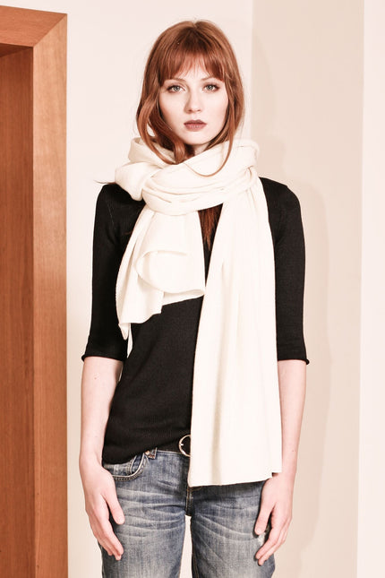 Introducing KIM, your year-round wardrobe essential – a versatile off-white cashmere knitted scarf and travel wrap that combines comfort and style seamlessly.