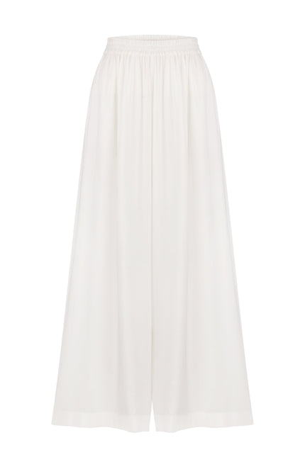 A pair of white wide-leg trousers made of cotton, with an elastic band at the waist for comfort.